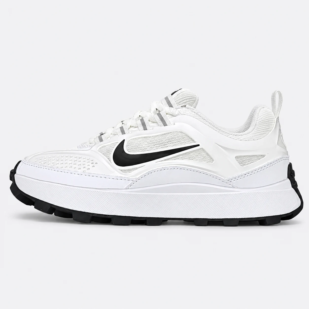 Nike Low-Top Runner — White / Black White / Black low-top sneaker with lace-up fastening, layered panels and visible Swoosh branding. Browse the cleaned catalogue image and original supplier photo, and select your UK size from 3 to 9.