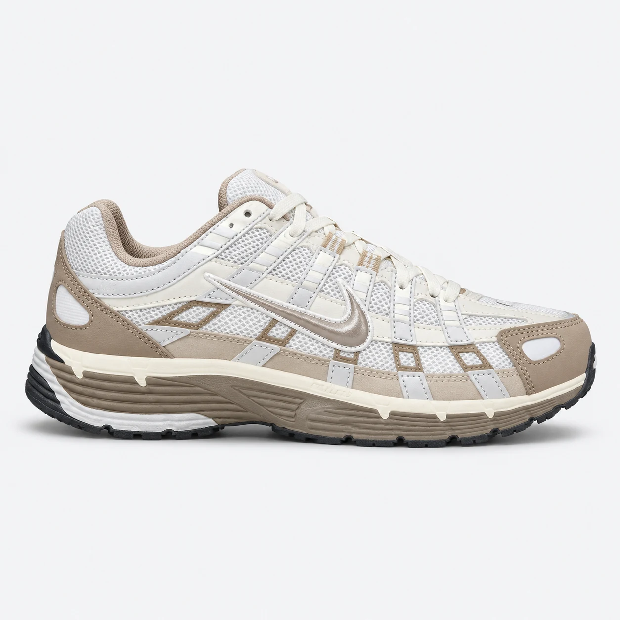 Nike P-6000 — White / Beige White / Beige low-top sneaker with lace-up fastening, layered panels and visible Swoosh branding. Browse the cleaned catalogue image and original supplier photo, and select your UK size from 3 to 9.