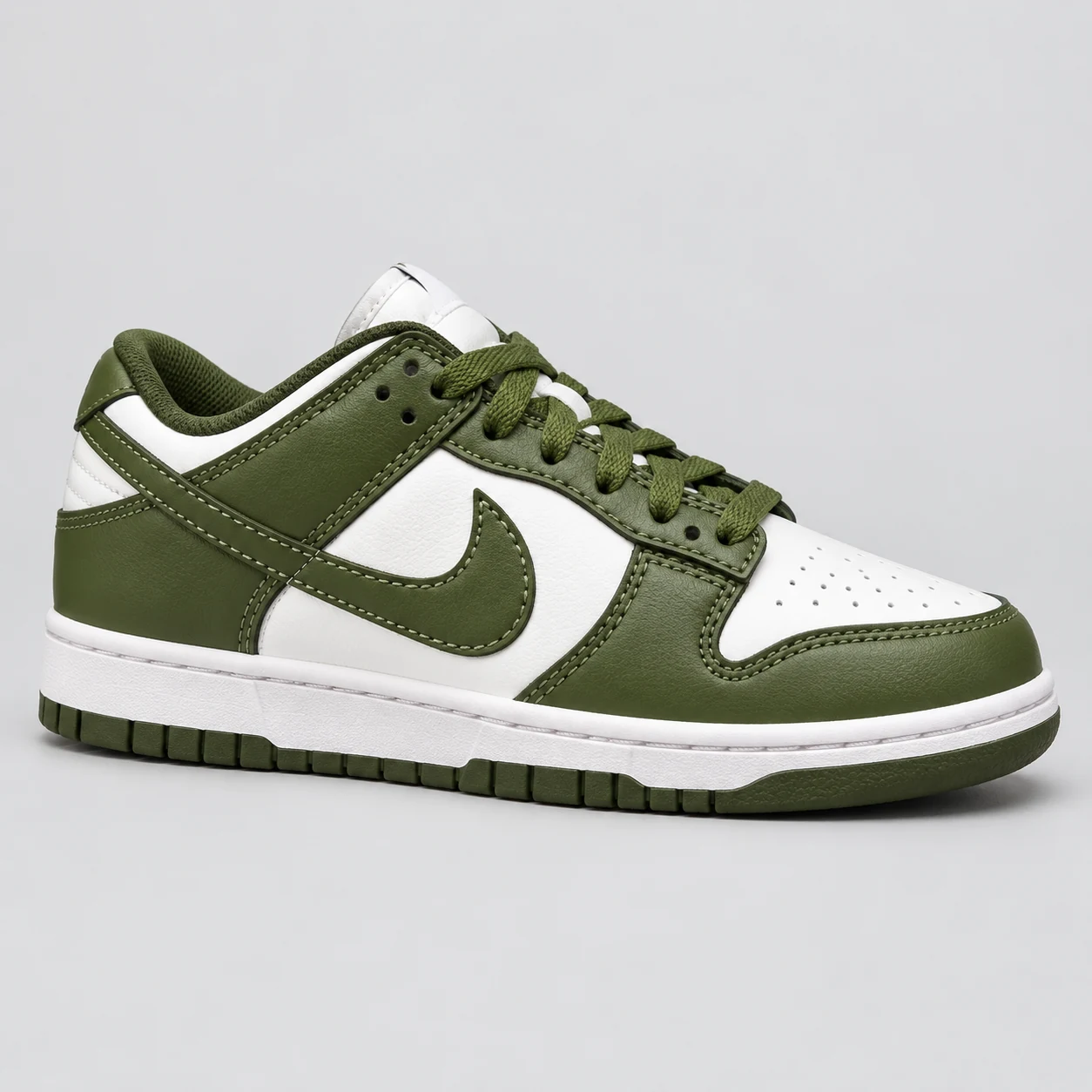Nike Dunk Low — Olive / White An olive and white low-top sneaker with matching olive laces, layered colour-block panels, a perforated toe and an olive outsole. Choose a UK size from 3 to 9 and view the product photos at The Drip Society.